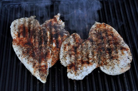 Three heart-shaped chicken breasts on the grill