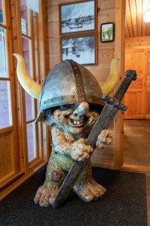 Figure of a troll with sword and helmet in Loen