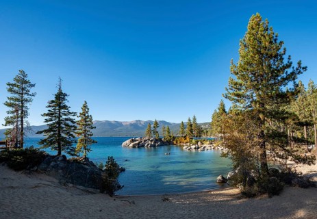 Sand beach and round stones in the water
