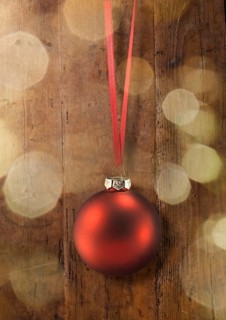 A red Christmas ball on a red ribbon
