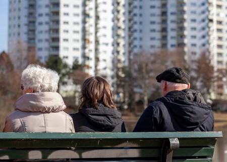 Seniors sitting on a park bench at the Segeluchbecken in the Maerkisches Viertel