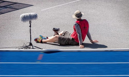Photographer with red waistcoat during an athletics event at the Olympiastadion