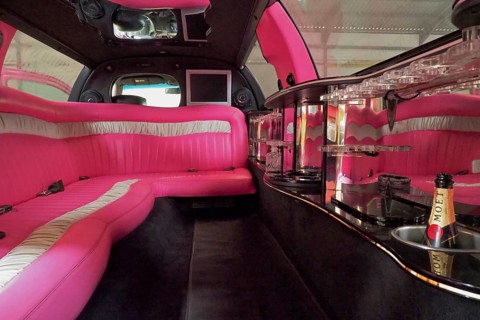 Luxury interior of a stretch limousine with pink upholstery