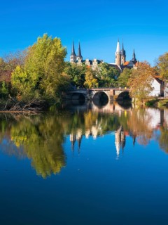 Merseburg Cathedral and Merseburg Castle reflected in the river Saale in autumn