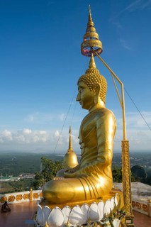 small golden pagoda on the temple hill in the evening