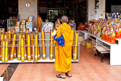Monk in front of shop with temple requirements