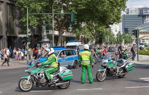 Traffic police officers on a motorbike regulate traffic during a demonstration