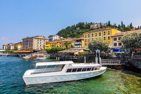 Ferry boat anchored in front of the promenade of Bellagio on Lake Como