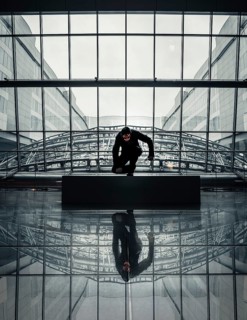 Man with Purge mask in a modern building