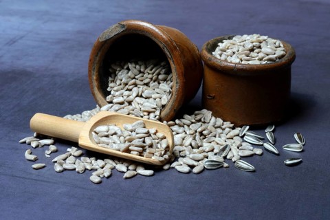 Peeled sunflower seeds in pots and scoops
