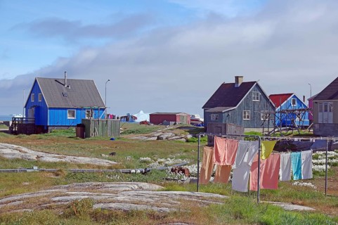 Laundry hanging in front of simple wooden houses