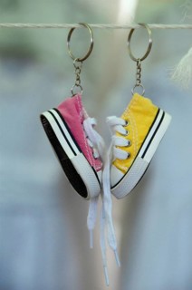 Sneakers as keychain on leash at market