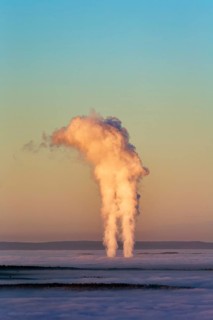 Two columns of steam rising from cloud cover