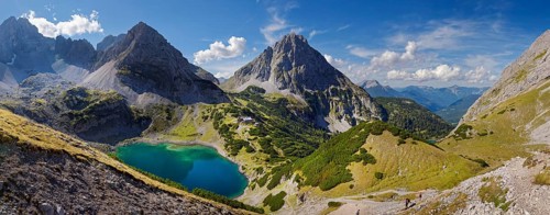 Mountain panorama above the Drachensee and the Coburger Huette with the mountain peaks of the Sonnenspitze