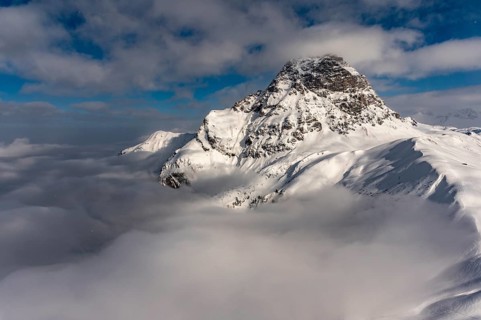 Summit of the Widderstein with mountains in the fog