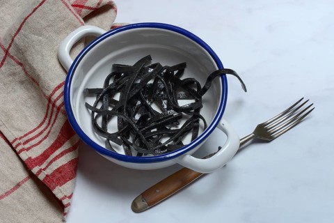 Black pasta with squid ink in bowl