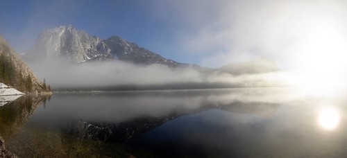 Fog clears in front of the Trisselwand at Lake Altaussee