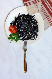 Black pasta with squid ink on plate