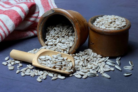 Peeled sunflower seeds in pots and scoops