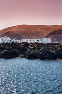 White houses on rocky lava coast