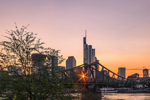 View over the Main River to the skyline of Frankfurt am Main at sunset