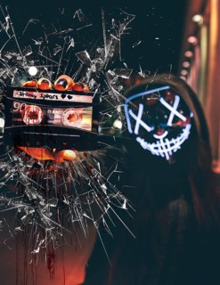 Man in Purge mask smashes sound cassette with Britnay Spears on glass pane