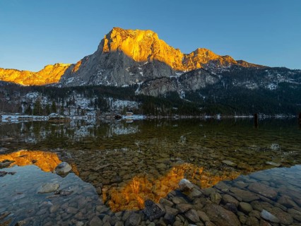 Evening sun illuminates the Trisselwand at Lake Altaussee