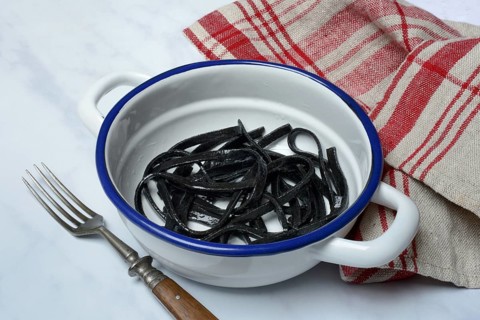 Black pasta with squid ink in bowl