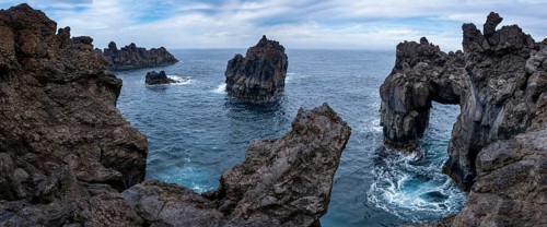 Rocky lava coast with rock gate