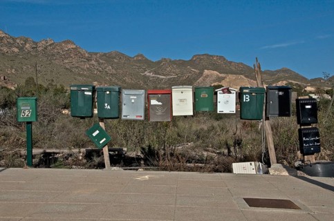Several mailboxes next to each other on a street