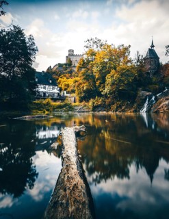 Pyrmonter mill at the waterfall of Elzbach with the castle Pyrmont in the back