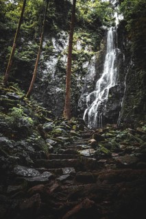The Burgbach waterfall in the middle of the green forest. Waterfall in Schapbach