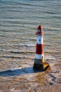 Red and white lighthouse in the sea