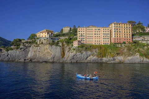 Historic skyscrapers and fishing boat leaving the port of