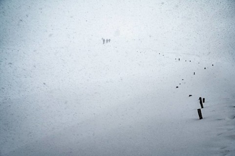 Ski tourers in heavy snowfall