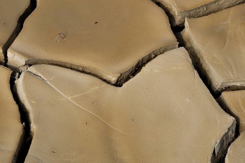 Dried clay soil with deep furrows