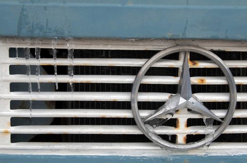 Mercedes star on radiator grille of truck with icicles