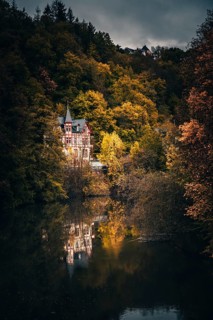View of a half-timbered house in the forest by the river Weilburg
