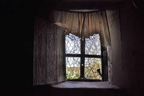 Window with plastic curtain in abandoned house