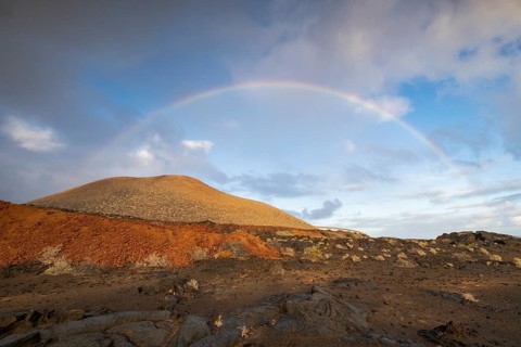 Rainbow and typical volcanic landscape at La Restinga