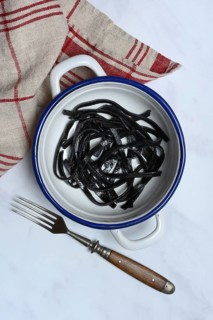 Black pasta with squid ink in bowl