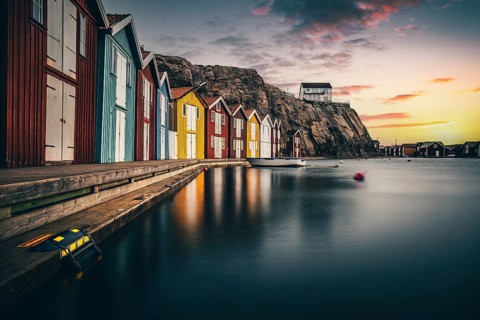 Boats and colourful boathouses in the harbour of Smoegen