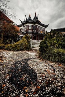 China restaurant with a great park and yin yang signs made of stones in the path