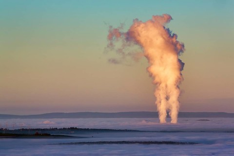Two columns of steam rising from cloud cover
