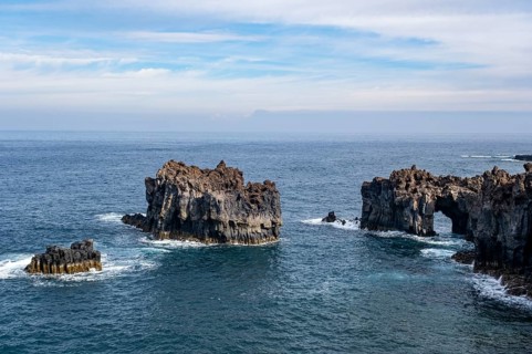 Rocky lava coast with rock gate