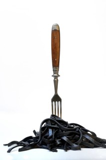 Black pasta with squid ink with fork