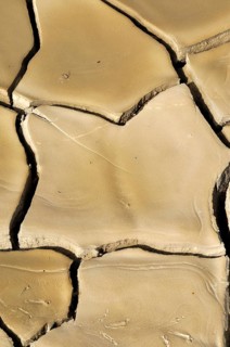 Dried clay soil with deep furrows