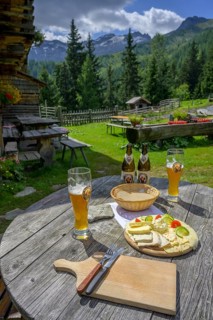 Wheat beer and cheese snack at the Modereggalm