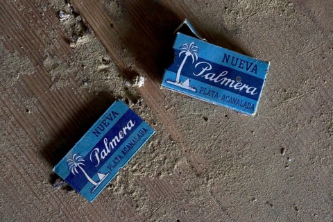 Old packets of razor blades on dusty wooden table