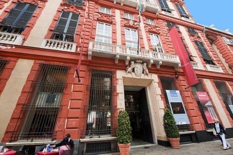 Entrance and red facade of Palazzo Rosso in the historic centre of Genoa